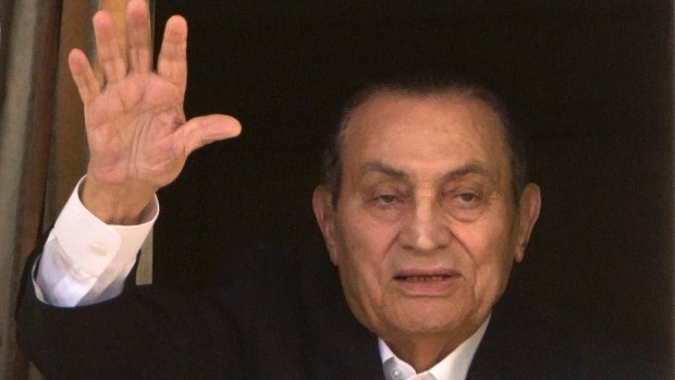 Former Egyptian president Hosni Mubarak waves to his supporters from his room at the Maadi Military Hospital last year.