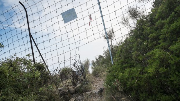 A hole in the fence at the border beckons refugees from sub-Saharan Africa trying to get from Italy to France. 