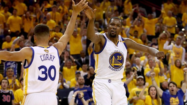Dream team Kevin Durant and Steph Curry give a high five.