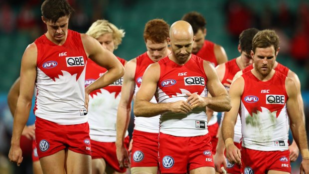 On that got away: Jarrad McVeigh leads a dejected Swans team off the field.