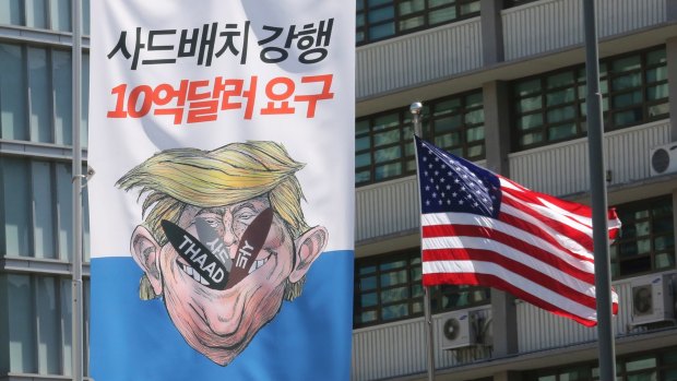 A banner with an illustration of US President Donald Trump near the US Embassy in Seoul.