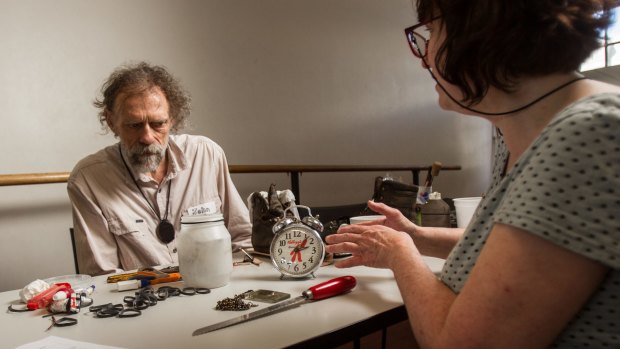 Taking their time: Karla Strambini, right, came from Montmorency, across town, to have the leg of her alarm clock fixed by John Harland, a volunteer at the Melbourne Repair Cafe.