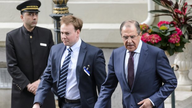 Russian Foreign Minister Sergei Lavrov, right, leaves the hotel during a break of the new round of talks on Iran's nuclear program, in Lausanne on Monday.