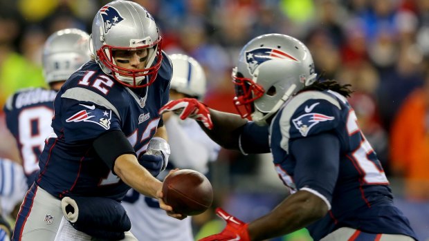 Back for Pats: Tom Brady hands the ball off to  LeGarrette Blount.
