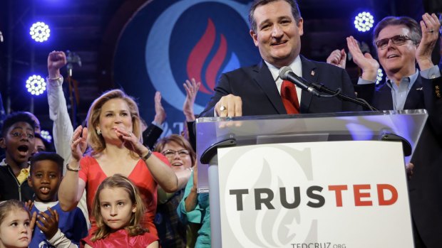 Republican presidential candidate Senator Ted Cruz addresses the crowd during an election night watch party in Stafford, Texas. Heidi Cruz and his daughters are at left. 