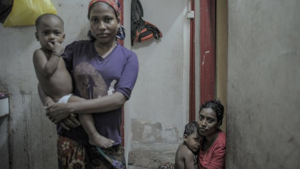 Rohingya refugee women from Myanmar holding their children in Ampang, Kuala Lumpur. A new law in Myanmar could dictate when a woman can have a child.