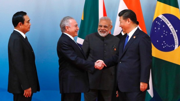 Chinese President Xi Jinping, right, greets Brazilian President Michel Temer, second from left, as Thai Prime Minister Prayuth Chan-ocha, left, and Indian Prime Minister Narendra Modi look on at the BRICS Summit in China on September 5.