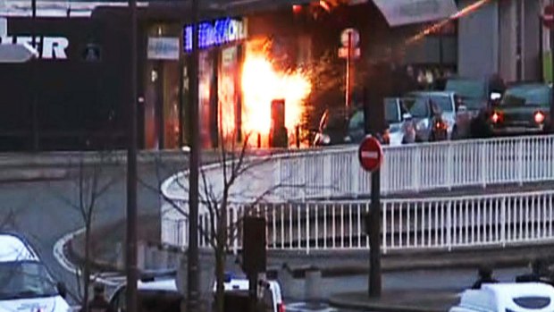 A screengrab taken from an AFP TV video shows a general view of members of the French police special forces launching the assault at a kosher grocery store in Porte de Vincennes, eastern Paris.