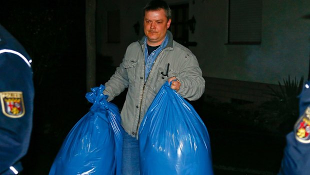 German police officers carry bags of evidence out of a house in Montabaur that belongs to the parents of crashed Germanwings co-pilot Andreas Lubitz. 