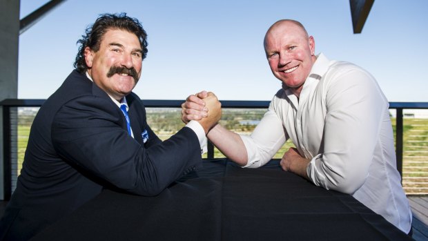 Robert DiPierdomenico and Barry Hall arm-wrestle at the AFL grand final lunch in Canberra on Tuesday.