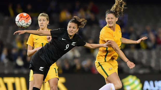 Matilda Laura Alleway heads the ball past New Zealand's Amber Hearn at Etihad Stadium