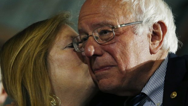 Bernie Sanders gets a kiss from his wife, Jane O'Meara Sanders, at a rally on Tuesday.