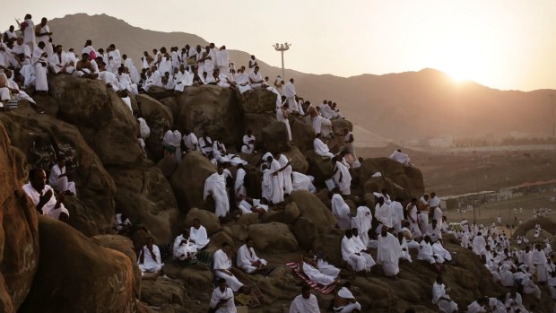 Muslim pilgrims pray on the Mountain of Mercy during The Haj. Mount Arafat, marked by a white pillar, is where Prophet Muhammad is believed to have delivered his last sermon to tens of thousands of followers some 1400 years ago, calling on Muslims to unite.