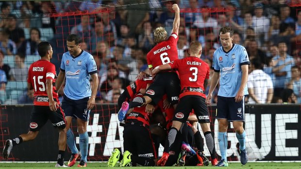 First blood: Wanderers celebrate after Brendon Santalab scored the only goal of the match. 