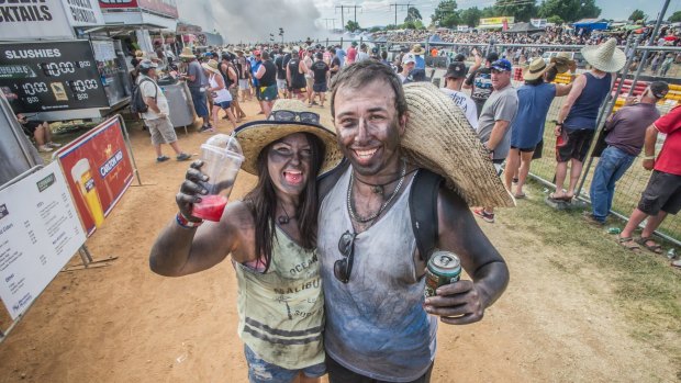 First-time Summernats patrons Amy Judd and Chris Meli of Melbourne have spent five hours in the front row of the burnouts competition at 2017 Summernats. 