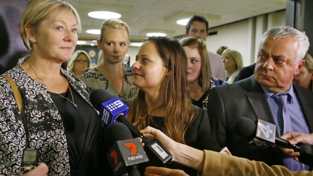 Donna Lane, left, mother of victim  Chris Lane, speaks as she leaves the courtroom. Looking on are Lane's American girlfriend, Sarah Harper, second from left, Lane's sister, Erin Lane, centre, and Lane's father, Peter Lane, right. 