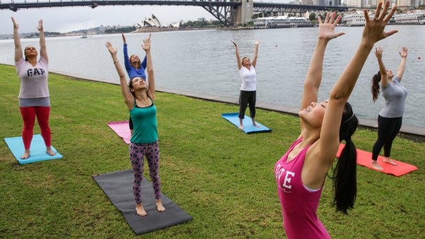 Jospehine Lau (pink top) is one of a growing number of yoga teachers offering classes in Holy Yoga. 