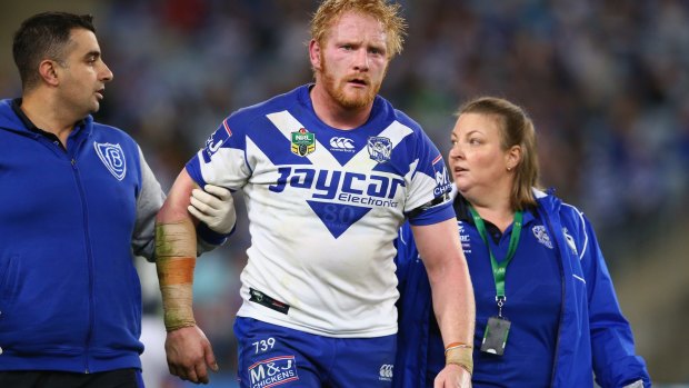 Sidelined: James Graham leaves the field after being knocked out against the Roosters.