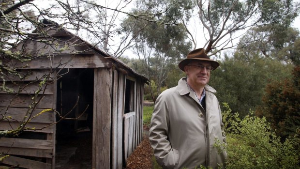 Allan Myers, QC, on his property in Dunkeld beside a hut where his great-grandfather lived.