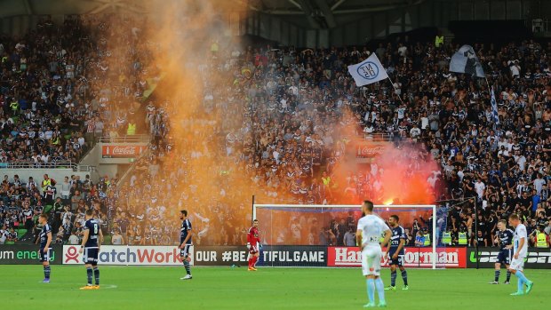 Fans set off flares during A-League Melbourne derby.