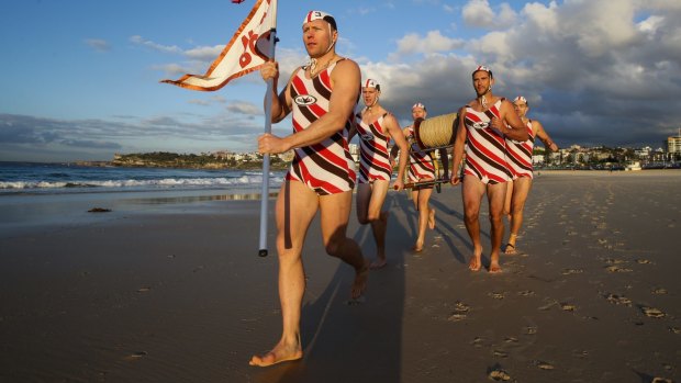 Luke Michael leads out members of North Bondi Surf Club who will be running the City to Surf in traditional club costumes with the surf reel to raise money for charity. 