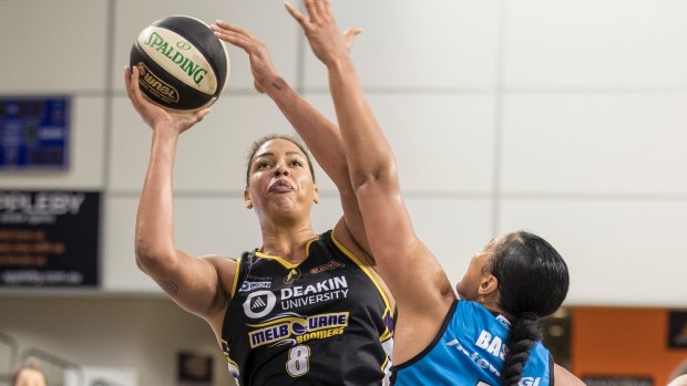 Centred: Melbourne's Liz Cambage launches a shot over Canberra's Mistie Bass.