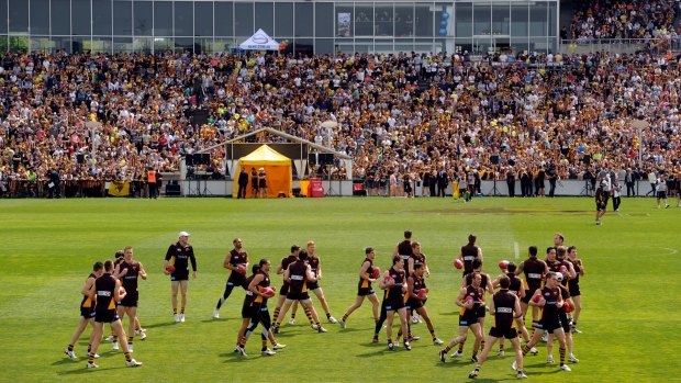 Supporters watch Hawthorn players at the final training day of 2012 Waverley.