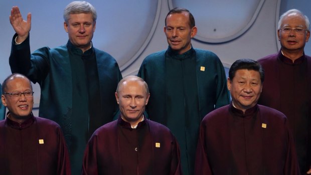 Prime Minister Tony Abbott between with Canadian Prime Minister Stephen Harper and Malysian leader Najib Tazak looks at Russian President Vladimir Putin. The two had a brief exchange in Beijing before more sideline talks at APEC. Chinese President Xi Jinping is to the right of Mr Putin.