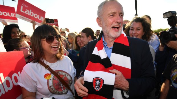 Labour Party leader Jeremy Corbyn is presented a Rotherham United F.C. scarf by a supporter during a campaign event on Wednesday.
