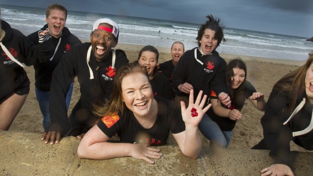 Brianna van't Hag (front, with Red Frog lolly) and fellow Red Frogs volunteers relax at Torquay in the lead-up to Victorian schoolies celebrations.