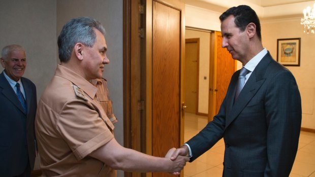 Syrian President Bashar al-Assad, right, shakes hands with Russian Defence Minister Sergei Shoigu in Damascus in June.