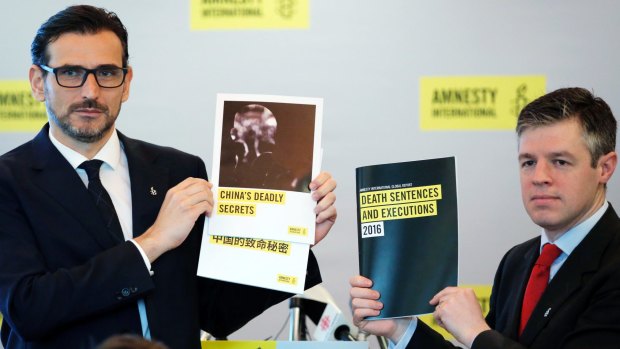 Amnesty International East Asia Director Nicholas Bequelin, left, and Deputy Director of Global Issues James Lynch hold the copies of reports.