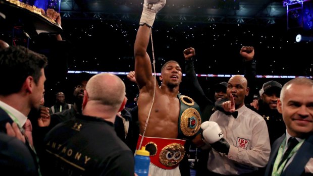Wrapping up: Heavyweight champion Anthony Joshua pictured wearing two of the three belts earned after an 11th round knockout of Wladimir Klitschko.