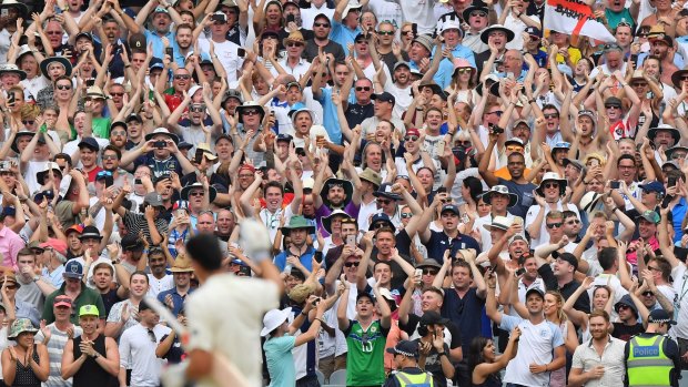 Appreciation: Cricket fans stand and applaud England's Alastair Cook as they celebrate Cook reaching 200 runs.
