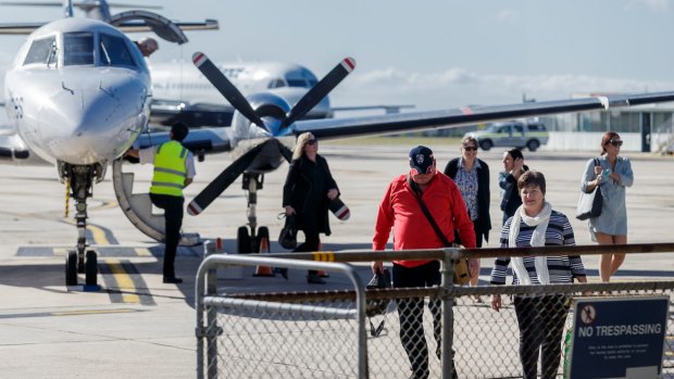 Passengers disembark a chartered flight at Essendon Fields Airport, Melbourne on Thursday.