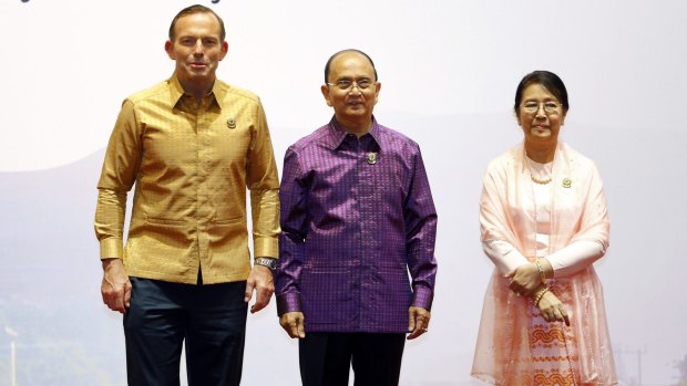 More casual: Tony Abbott is welcomed by Myanmar's President Thein Sein and his wife Khin Khin Win.