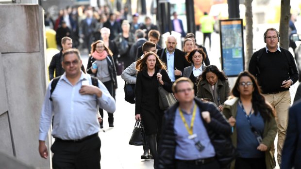 City workers on Collins Streeet, making their way into Docklands on Tuesday morning.