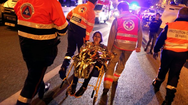 A person is evacuated after a shooting, outside the Bataclan theater in Paris.