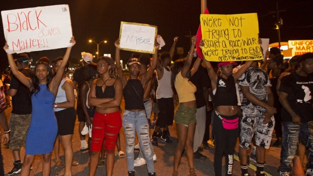 Protesters block a major road that passes in front of the Baton Rouge Police Department headquarters.