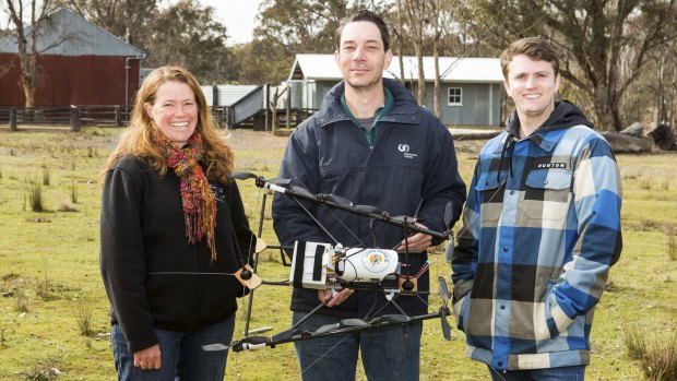 ANU researcher Dr Debra Saunders, with Jeremy Randle and Oliver Cliff of the University of Sydney, with their tracking drone.

