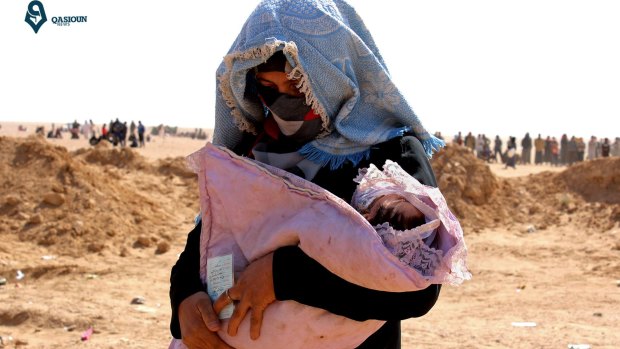 An Iraqi women who fled Mosul with her baby arrives in Hasakah, north-east Syria.