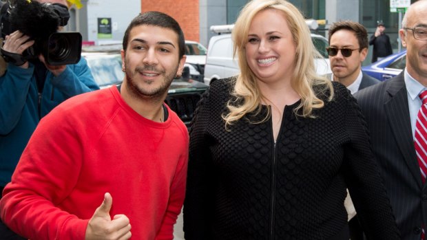 Actress Rebel Wilson stops for a photo with a fan as she arrived for her case at the Supreme Court in Melbourne. 