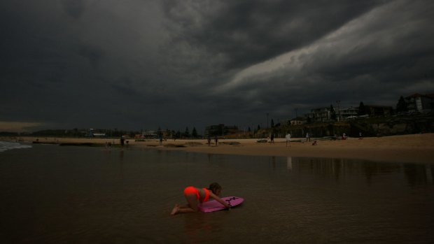 The storm darkens the sky over Maroubra Beach.
