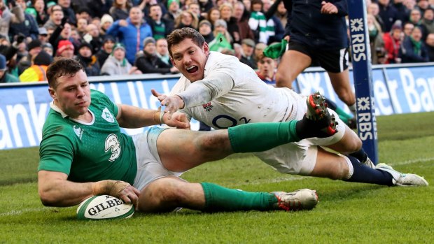 Rare sight: Robbie Henshaw crosses for Ireland's only try against England.