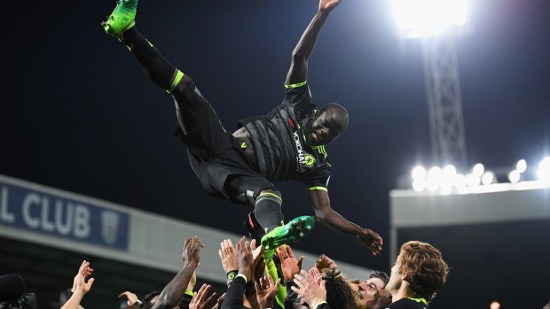 N'Golo Kante of Chelsea is chucked in the air while celebrating winning the title.