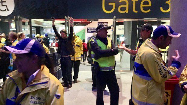 Police search fans entering the Melbourne Cricket Ground.