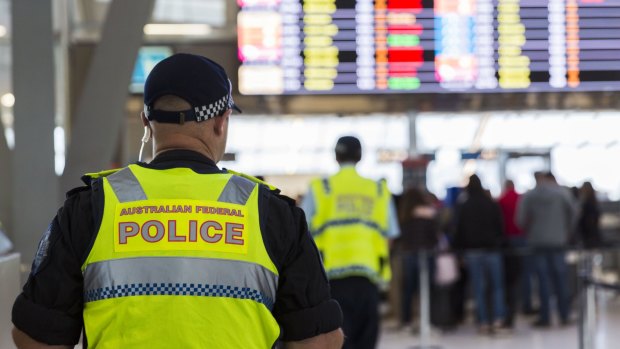 Police guard the passenger security check area at Sydney Airport on Sunday.