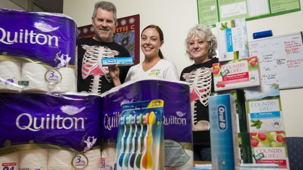 Hepatitis ACT executive officer John Didlick, GIVIT media manager Kayla Brereton and community educator Kerrie McKenzie with the donated items. 