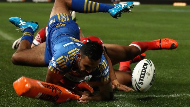 Close call: Bevan French of the Eels is tackled over the sideline as he attempts to score.
