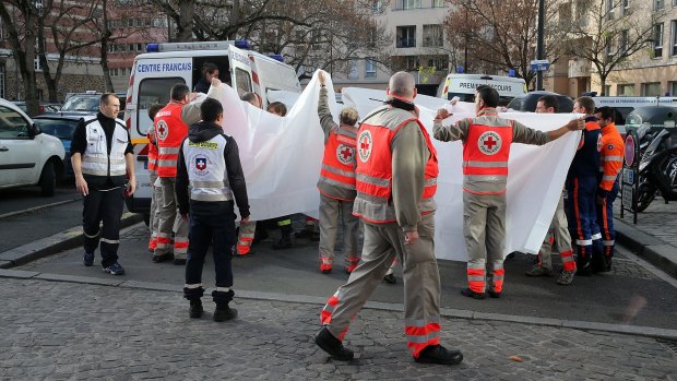 Medical staff transfer people to hospital after the Saint-Denis shootout.